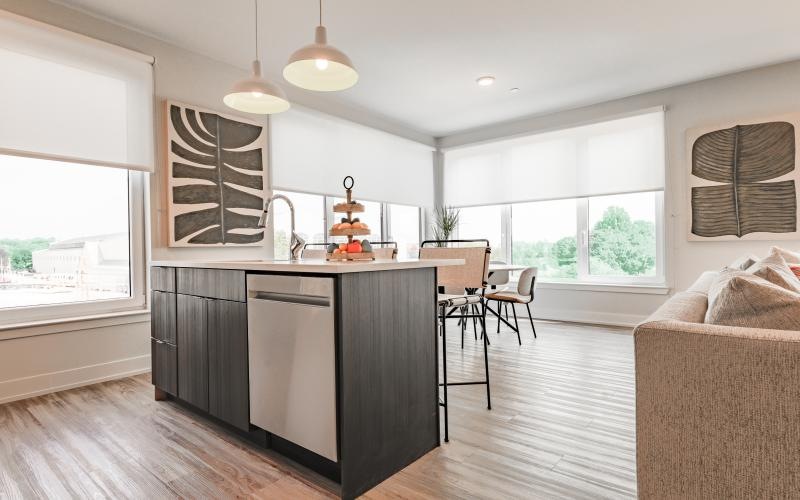 a kitchen with a bar and chairs