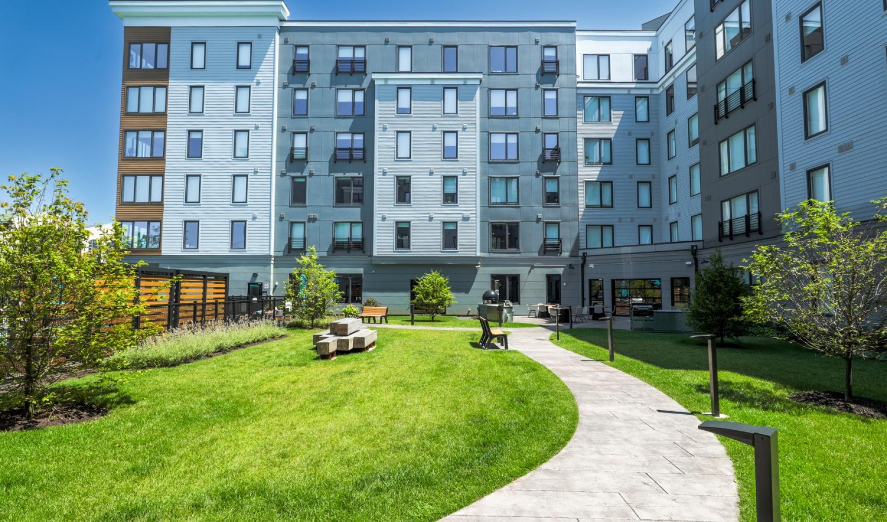 a building with a lawn and benches