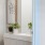 a bathroom with a sink and a plant on the counter