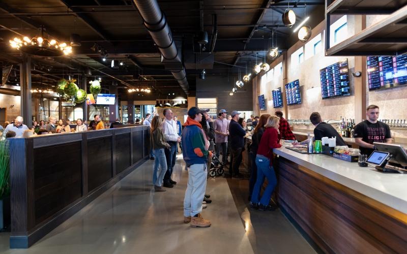 a group of people standing in a bar